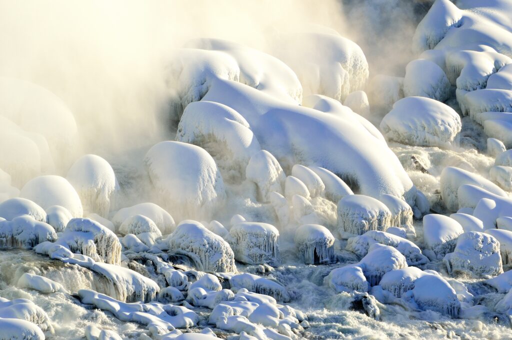 Snow and ice covered rocks at the base of Niagara Falls