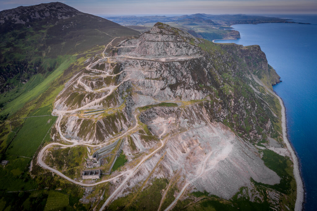 Aerial photo of a quarry with many curving roads and exposed rocks.