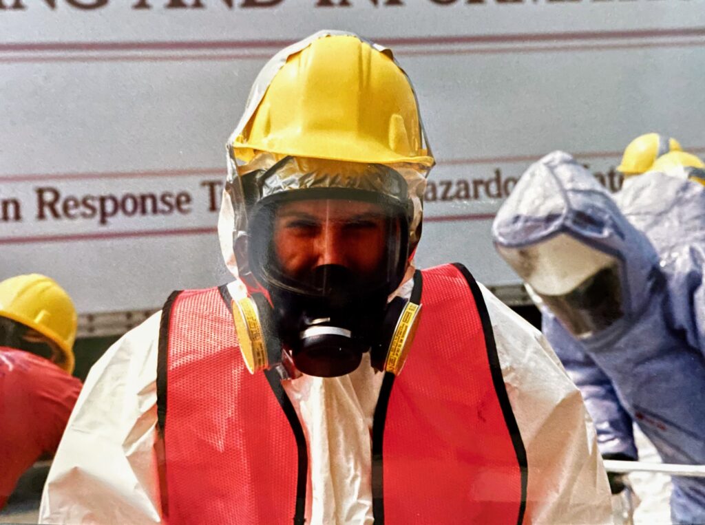 Woman in full PPE including helmet, mask and suit