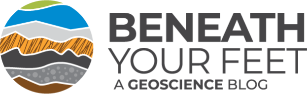 Logo for the blog. On the right there is a cut-out circle of a drawing. The drawing is of different kinds of rocks in small horizontal sections piled on top of one another. On the left text reads: "Beneath Your Feet. A Geoscience Blog."