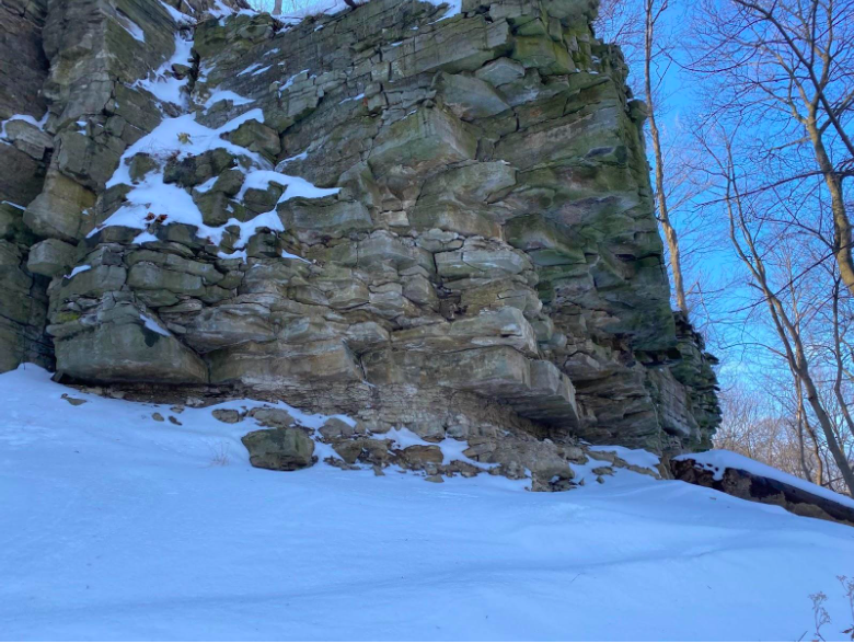 Cliffside in winter showing large angular blocky rocks.